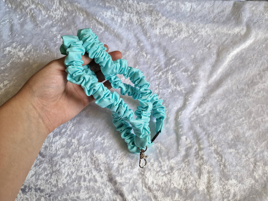Aqua ruffle lanyard with breakaway clasp. 