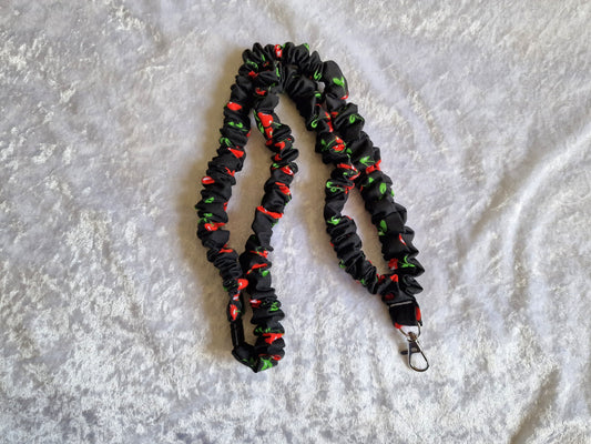 Black and red cherry ruffle lanyard with breakaway clasp.