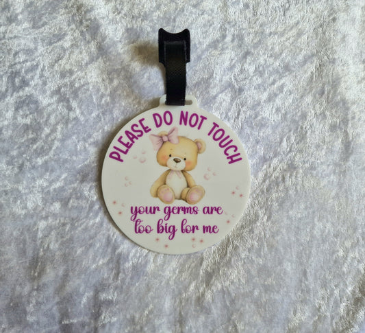 Pink bear do not touch pram tag attached to pram bar with velcro strap